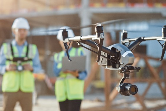 A drone controlled by people in yellow wests