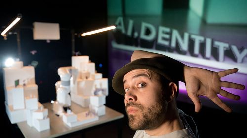 Man with hat and white boxes.