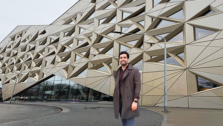 A man standing in front of a spectactular building