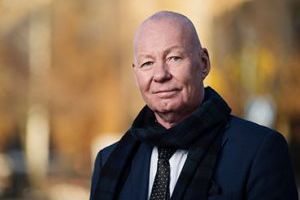 A man in at tie and scarf