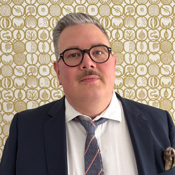 A man in a tie and glasses