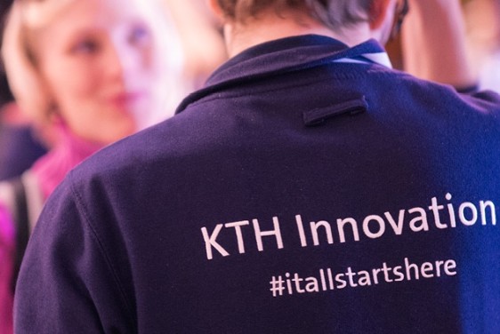 A man with his back turned, talking to a woman.