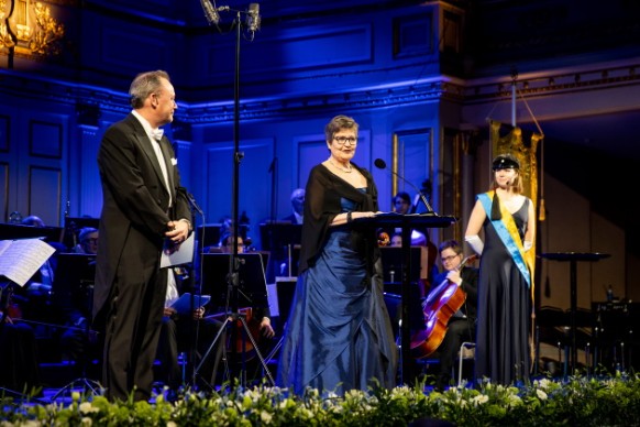Two women and one man on stage.