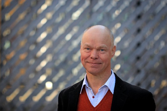 A man in a red sweater and black jacket