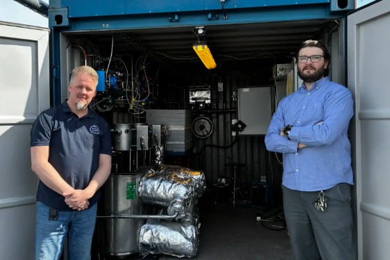 Two men in front of a test rig