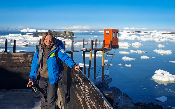 A woman standing in front of icy sea