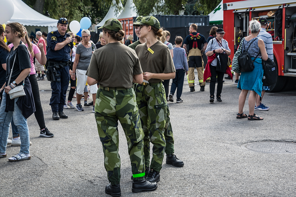 Three persons in military uniforms