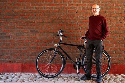 A man standing by a bike