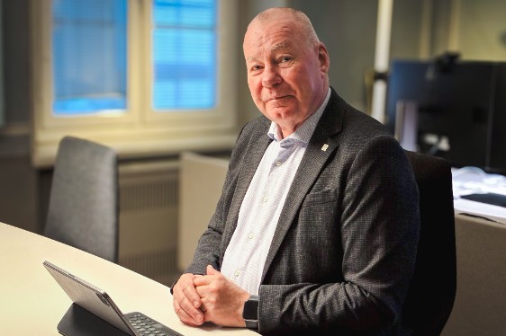 A man sitting by a desk