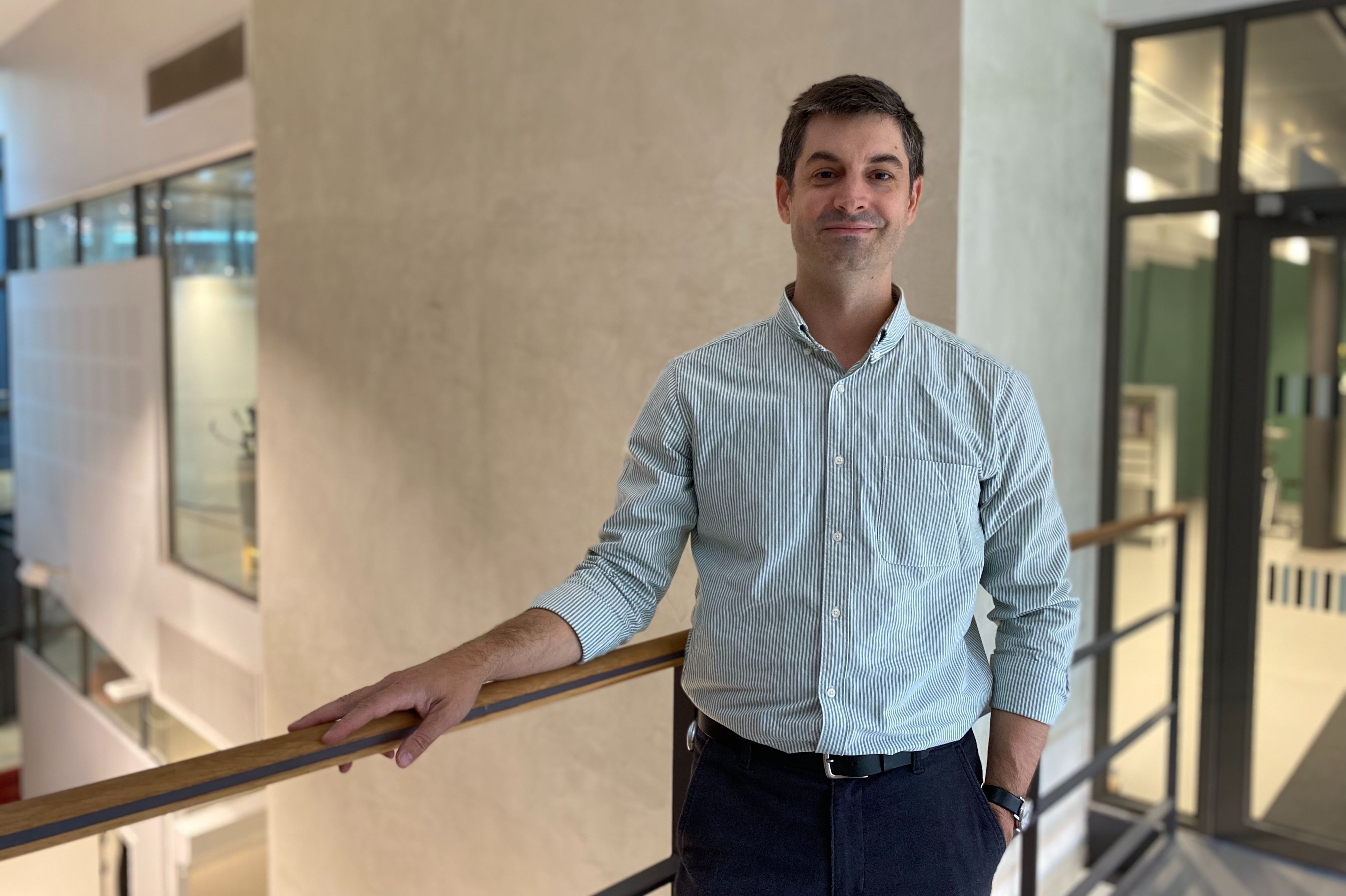 A man leaning against a hand rail
