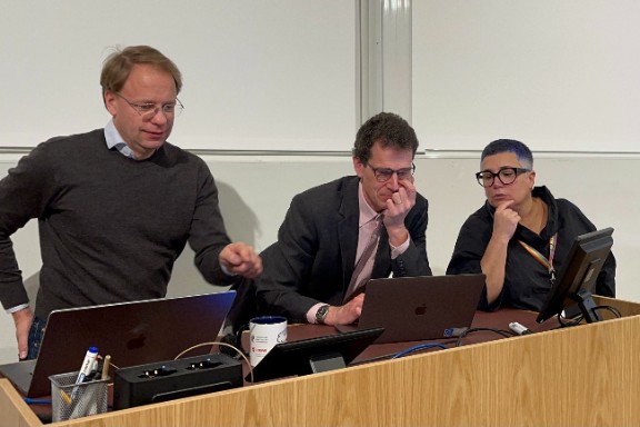 three people behind a table